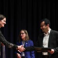 jenn shaking hands and handing the cord